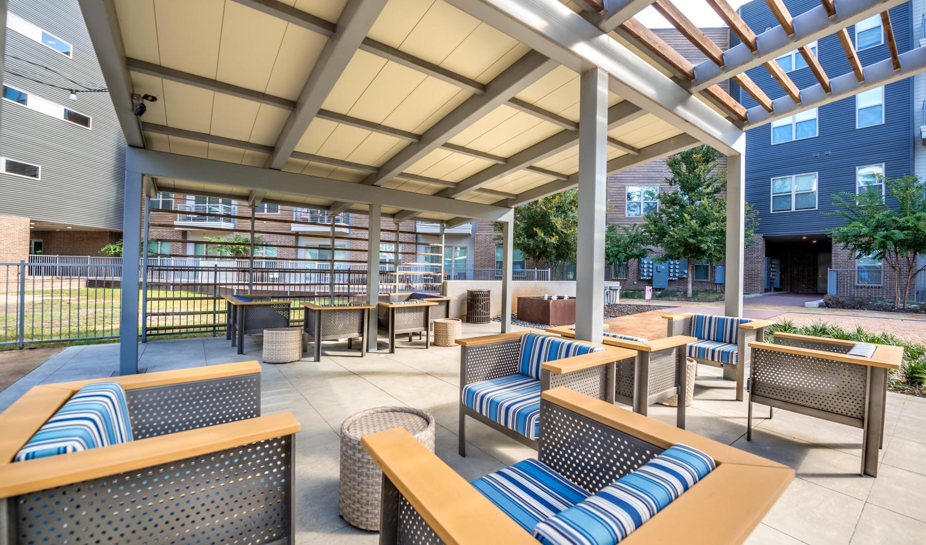 Settle into comfort at Atlas Waterside a patio with chairs and tables