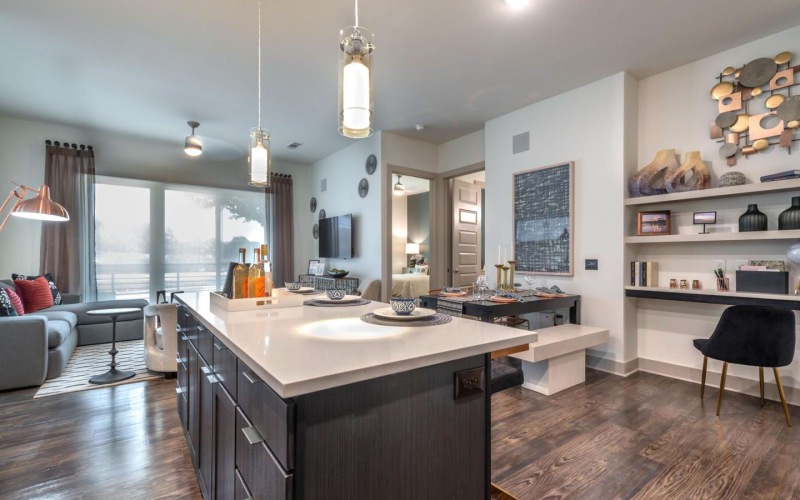a kitchen with a bar and chairs